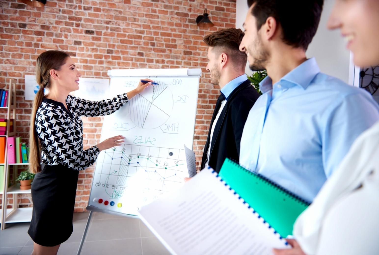 Team member analyzing business process optimization data on computer screens